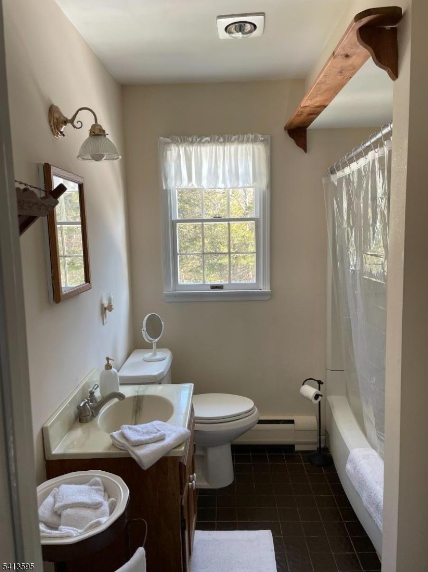 938 Potters Road Newton, NJ 07860 - Photo 19 of 26 a bathroom with a granite countertop toilet a sink and a mirror
