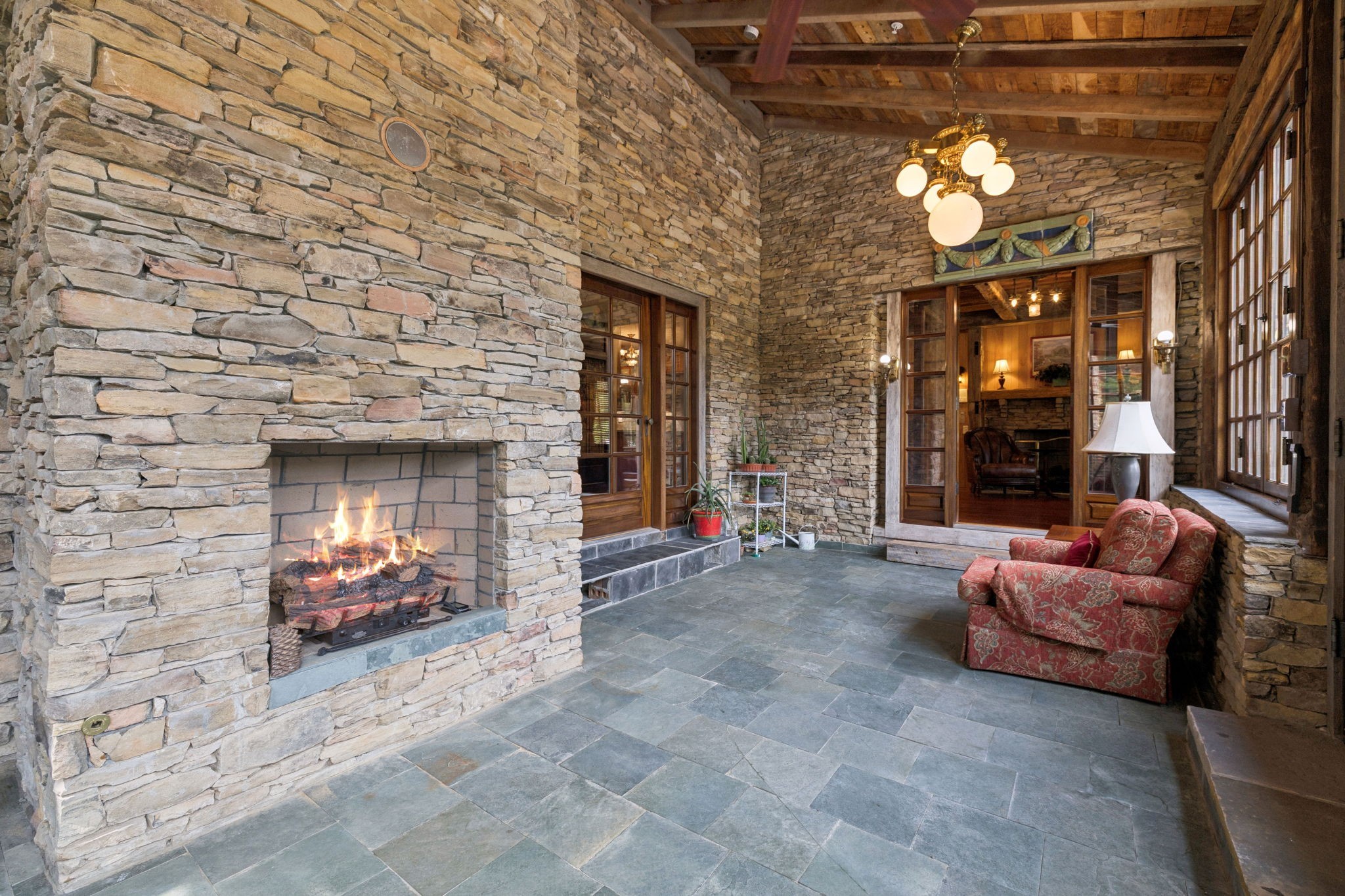 1374 Peter Pond Road Ashland City, TN 37015 - Photo 17 of 94 a living room with furniture a chandelier and a fireplace