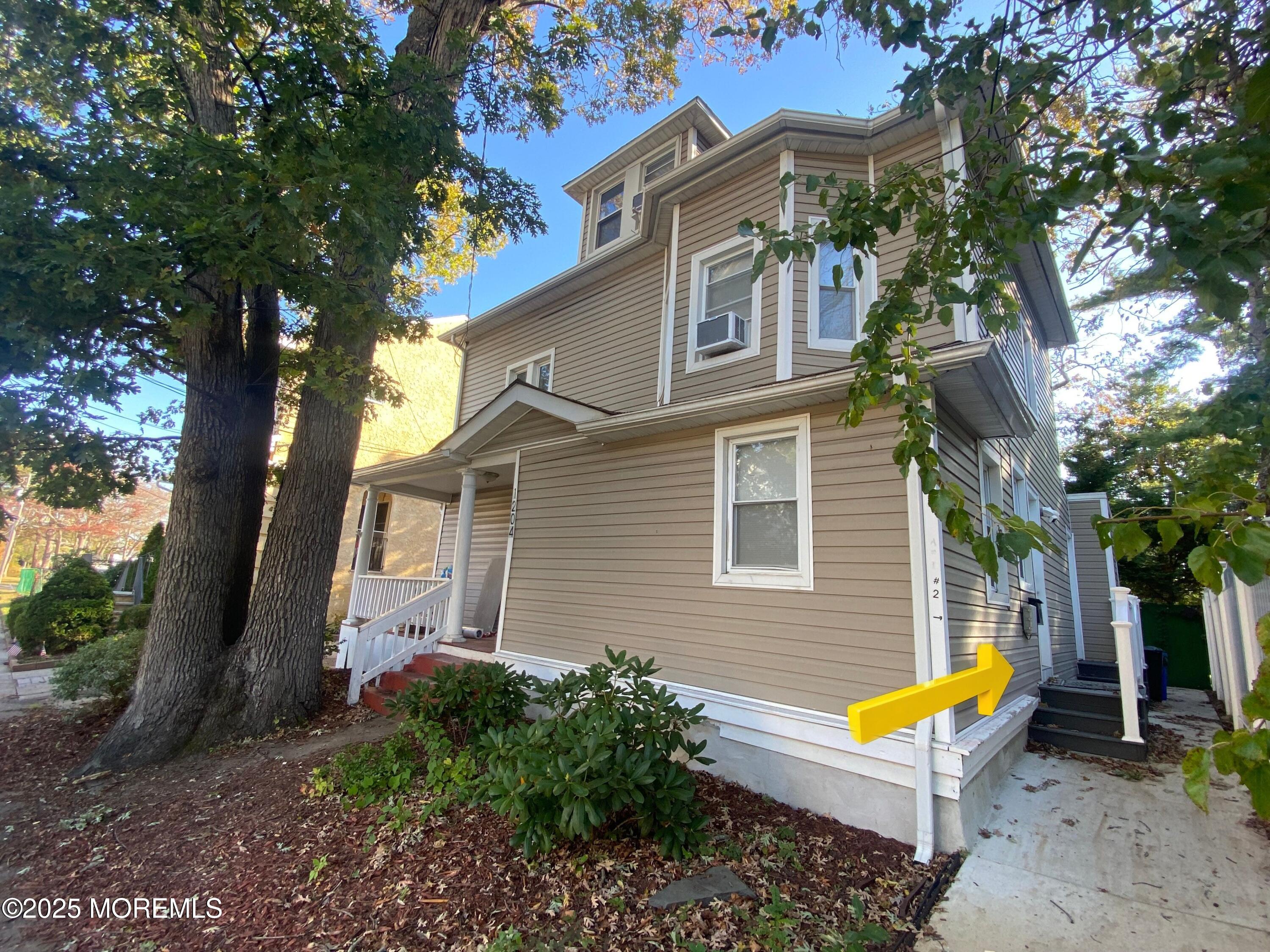 a view of a house with backyard and sitting area
