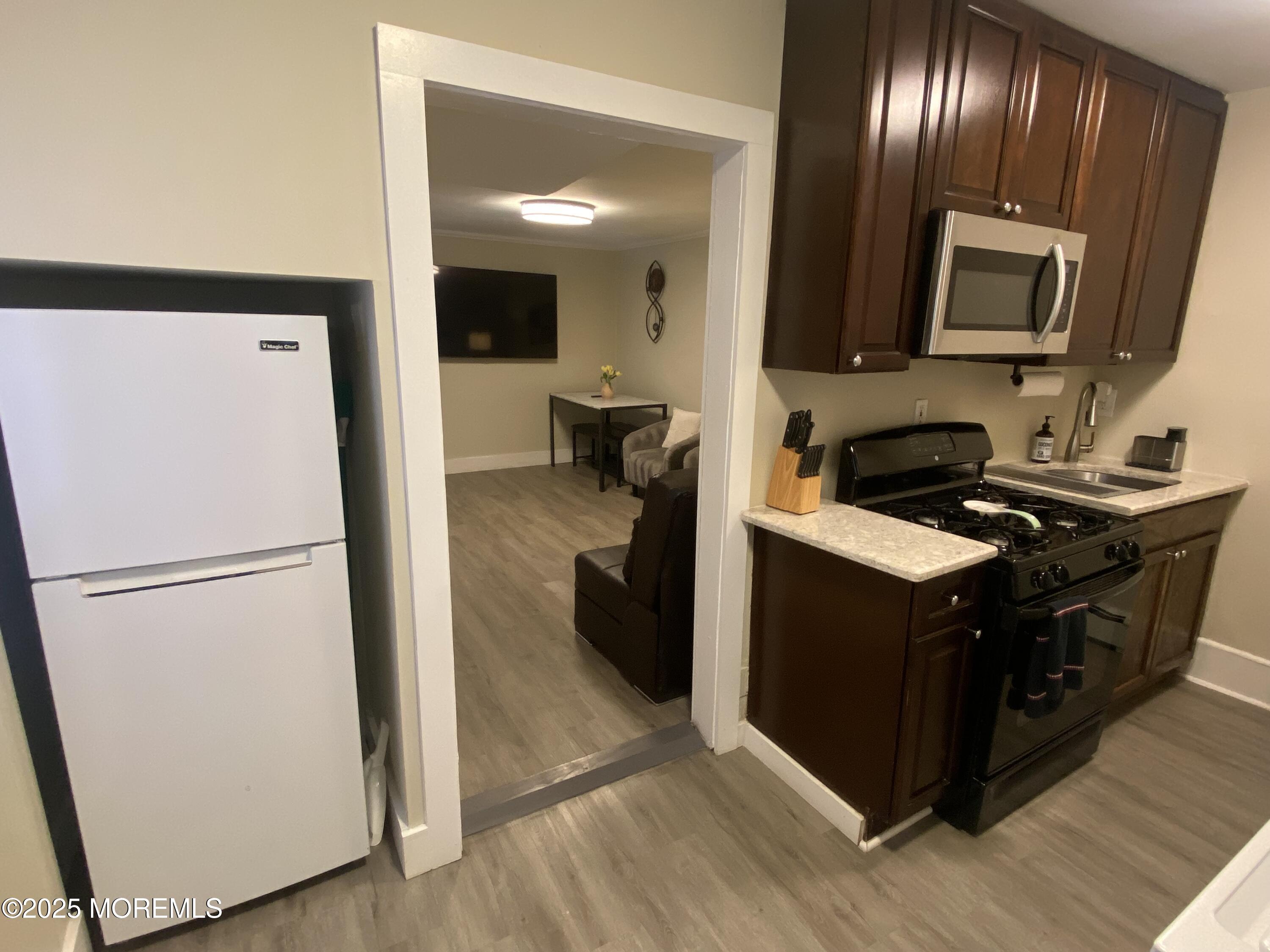 1204 Emory Street, Unit 2 Asbury Park, NJ 07712 - Photo 11 of 33 a kitchen with a refrigerator and a sink