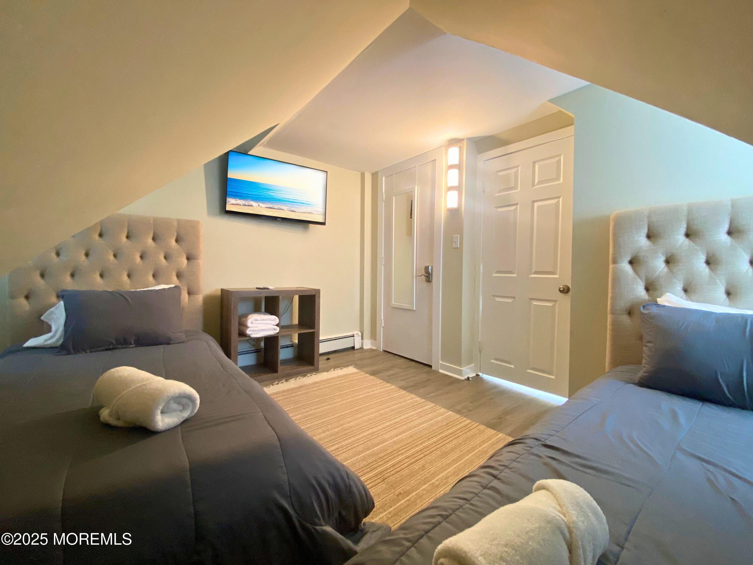 1204 Emory Street, Unit 2 Asbury Park, NJ 07712 - Photo 17 of 33 a bedroom with a bed and a couch