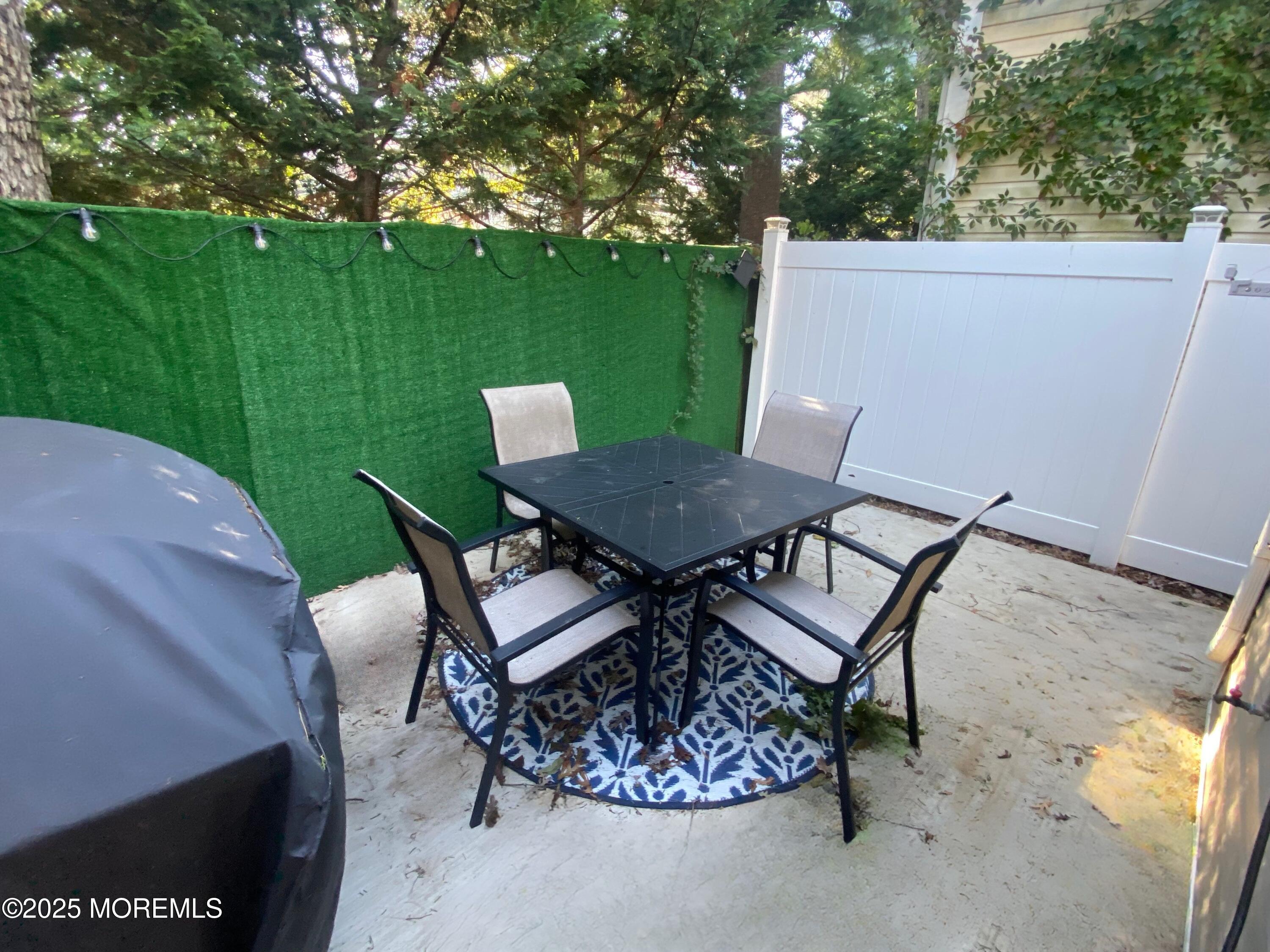 1204 Emory Street, Unit 2 Asbury Park, NJ 07712 - Photo 20 of 33 a view of a backyard with table and chairs