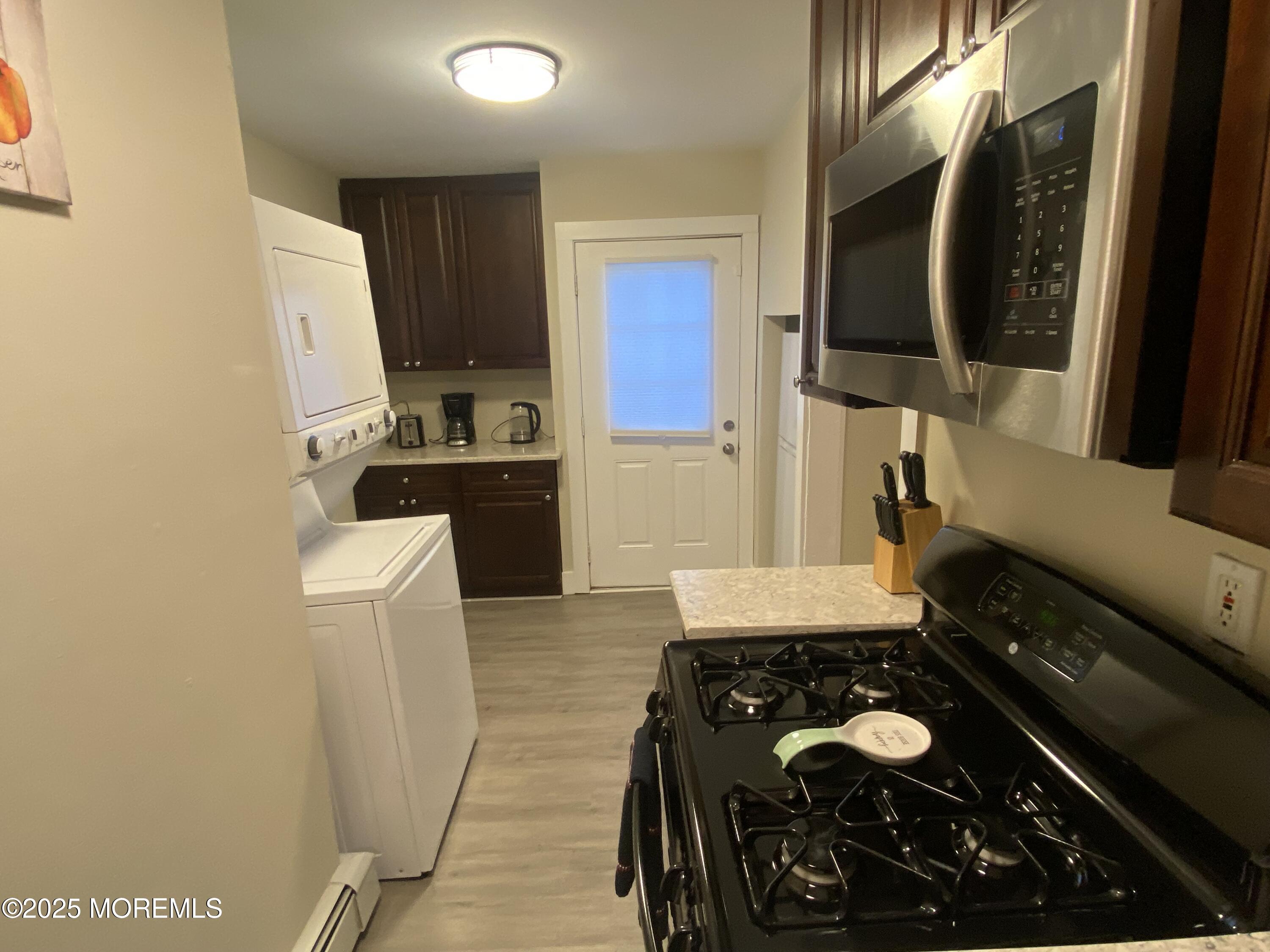 1204 Emory Street, Unit 2 Asbury Park, NJ 07712 - Photo 10 of 33 a kitchen with a stove and a refrigerator