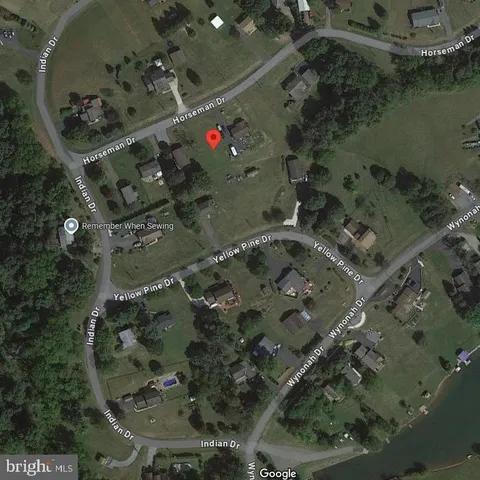 an aerial view of a residential houses with outdoor space