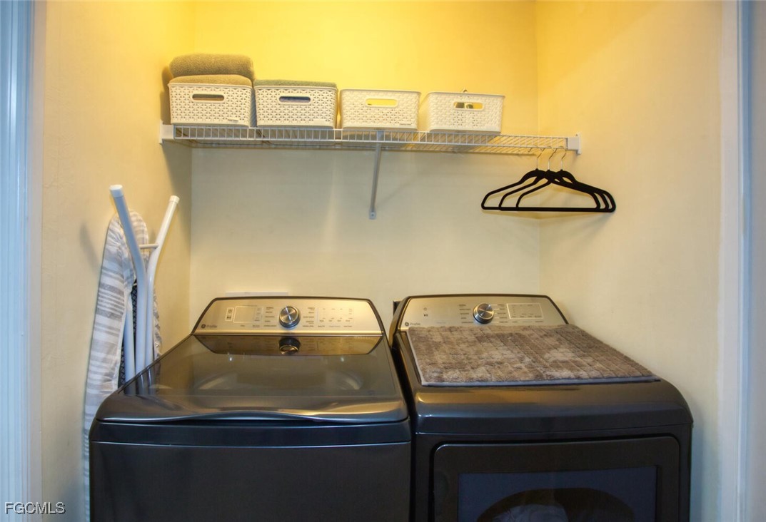 10461 Washingtonia Palm Way, Unit 3435 Fort Myers, FL 33966 - Photo 12 of 36 a utility room with dryer and washer