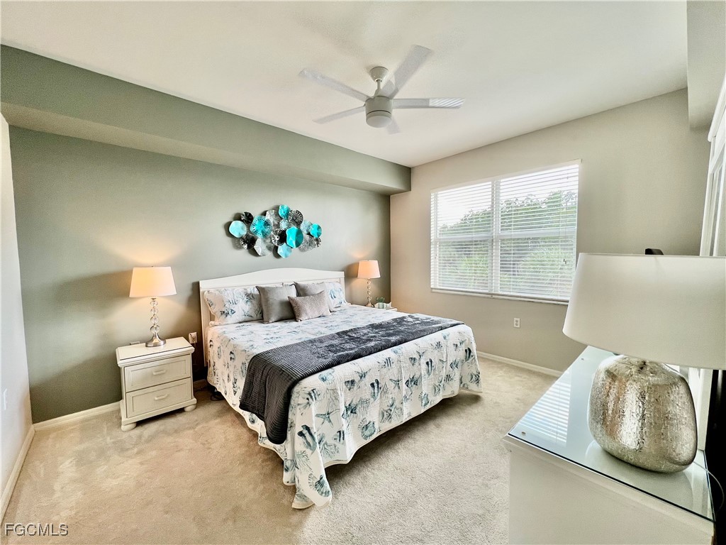 10461 Washingtonia Palm Way, Unit 3435 Fort Myers, FL 33966 - Photo 16 of 36 a bedroom with a large bed and a window