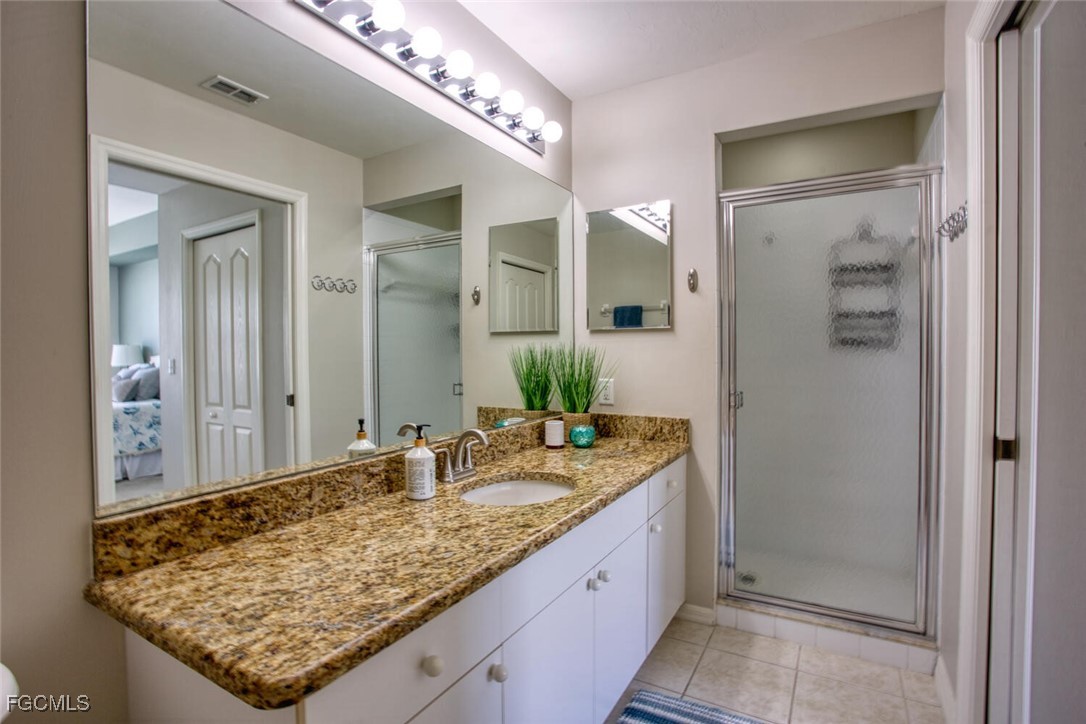10461 Washingtonia Palm Way, Unit 3435 Fort Myers, FL 33966 - Photo 17 of 36 a bathroom with a granite countertop sink and a mirror