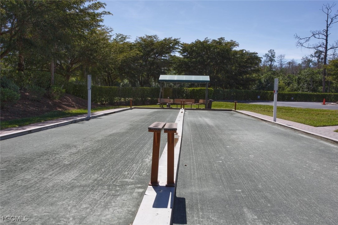 10461 Washingtonia Palm Way, Unit 3435 Fort Myers, FL 33966 - Photo 28 of 36 a view of a swimming pool with a yard and large trees