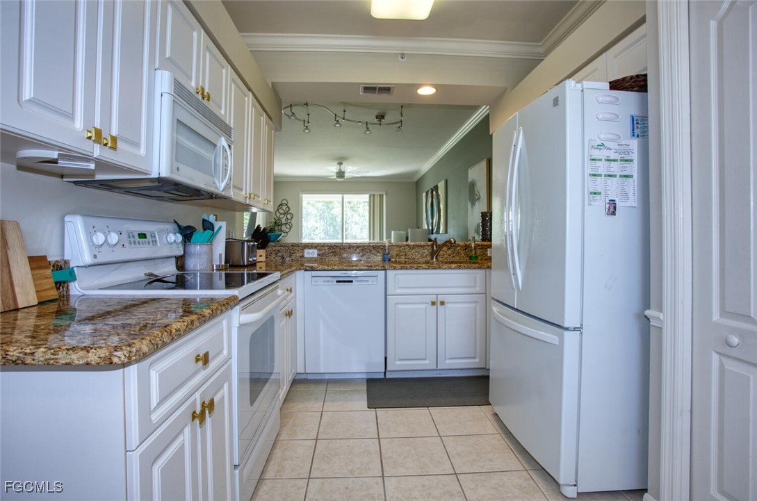 10461 Washingtonia Palm Way, Unit 3435 Fort Myers, FL 33966 - Photo 6 of 36 a kitchen with stainless steel appliances granite countertop a refrigerator and a stove