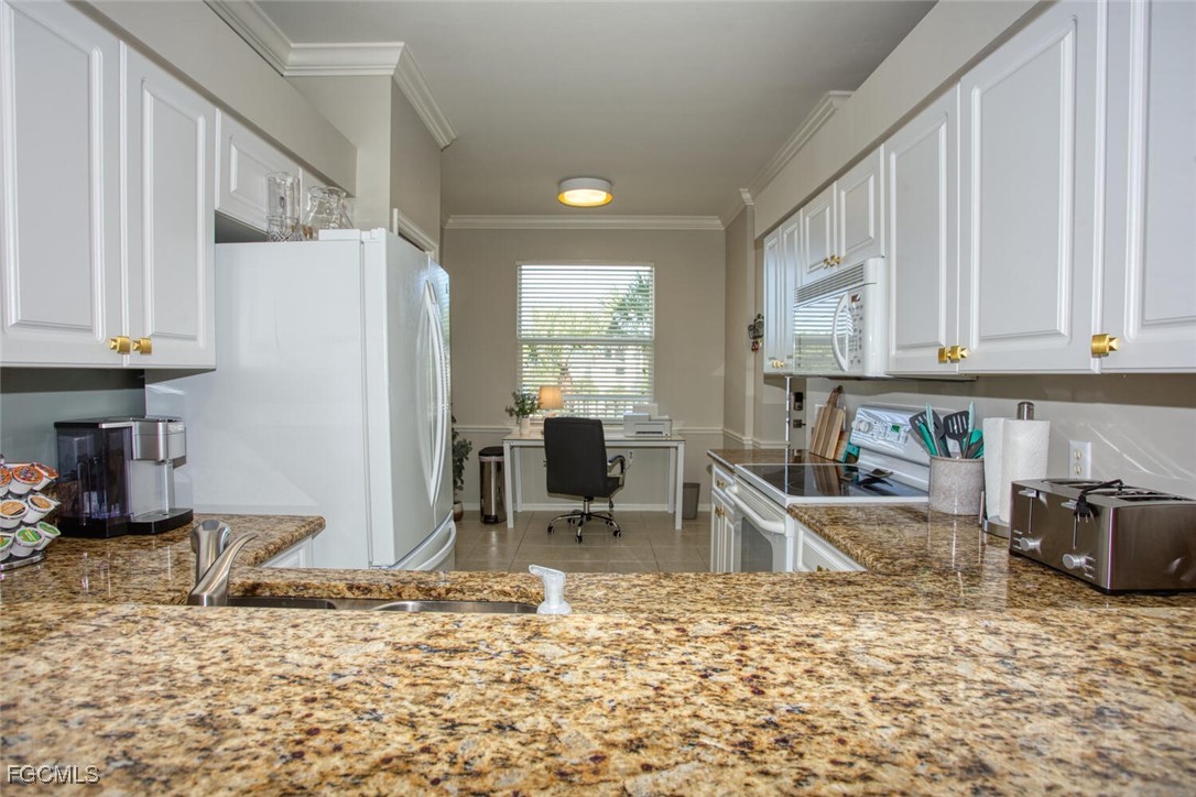 10461 Washingtonia Palm Way, Unit 3435 Fort Myers, FL 33966 - Photo 8 of 36 a kitchen with stainless steel appliances granite countertop a sink refrigerator and cabinets