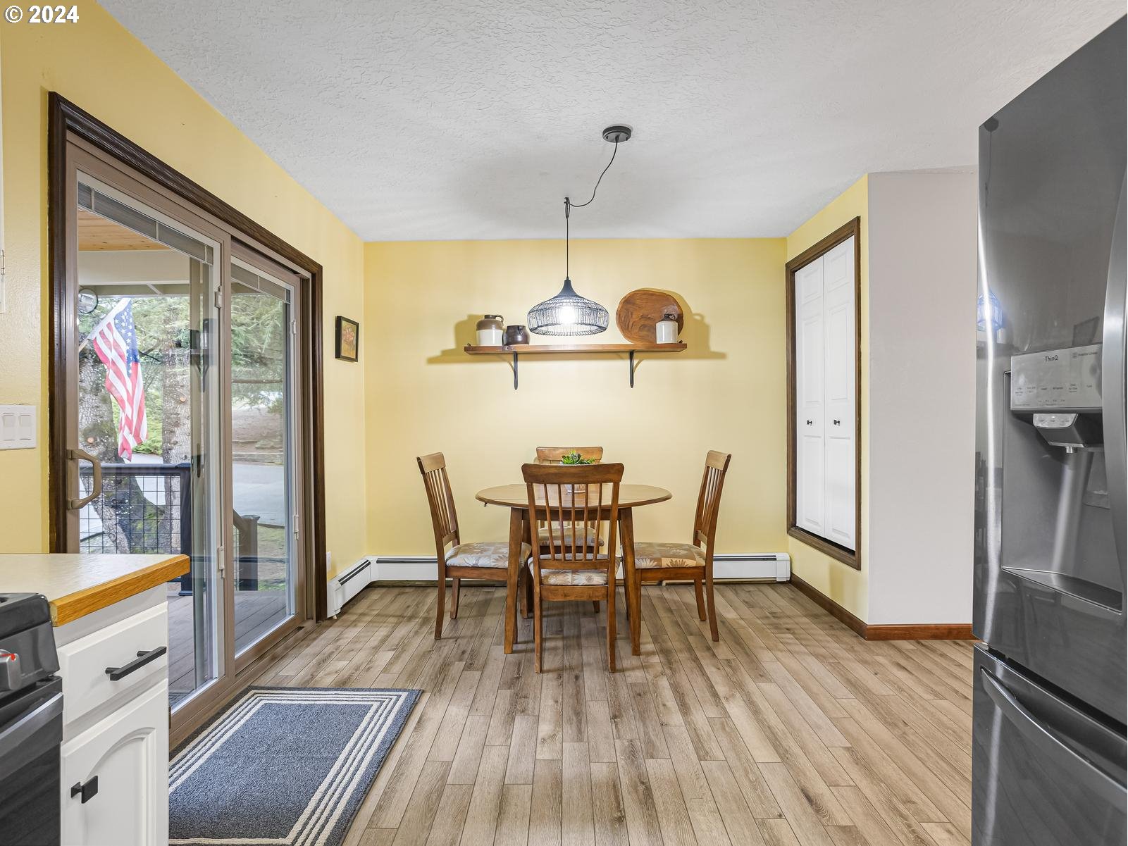 18550 Southeast Jacoby Road Sandy, OR 97055 - Photo 13 of 47 a view of a dining room with furniture a chandelier and wooden floor