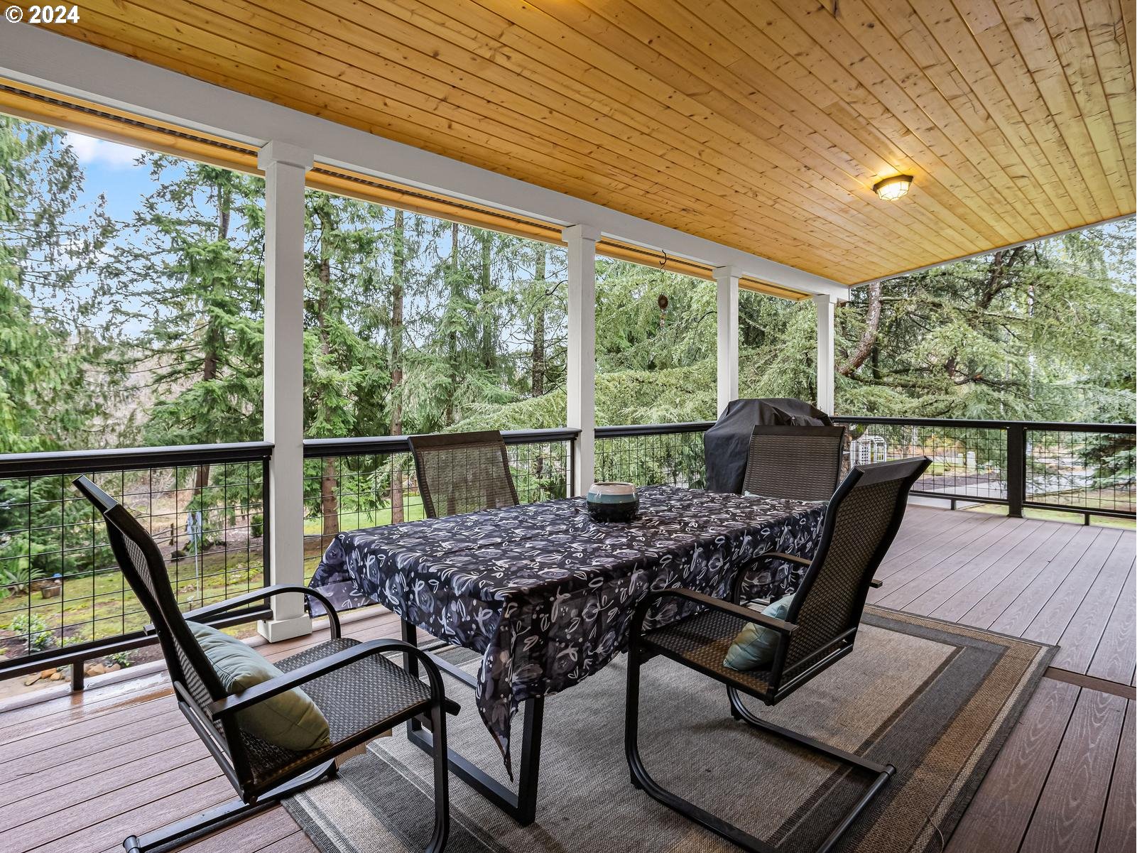 18550 Southeast Jacoby Road Sandy, OR 97055 - Photo 16 of 47 a view of a patio with lawn chairs and wooden floor