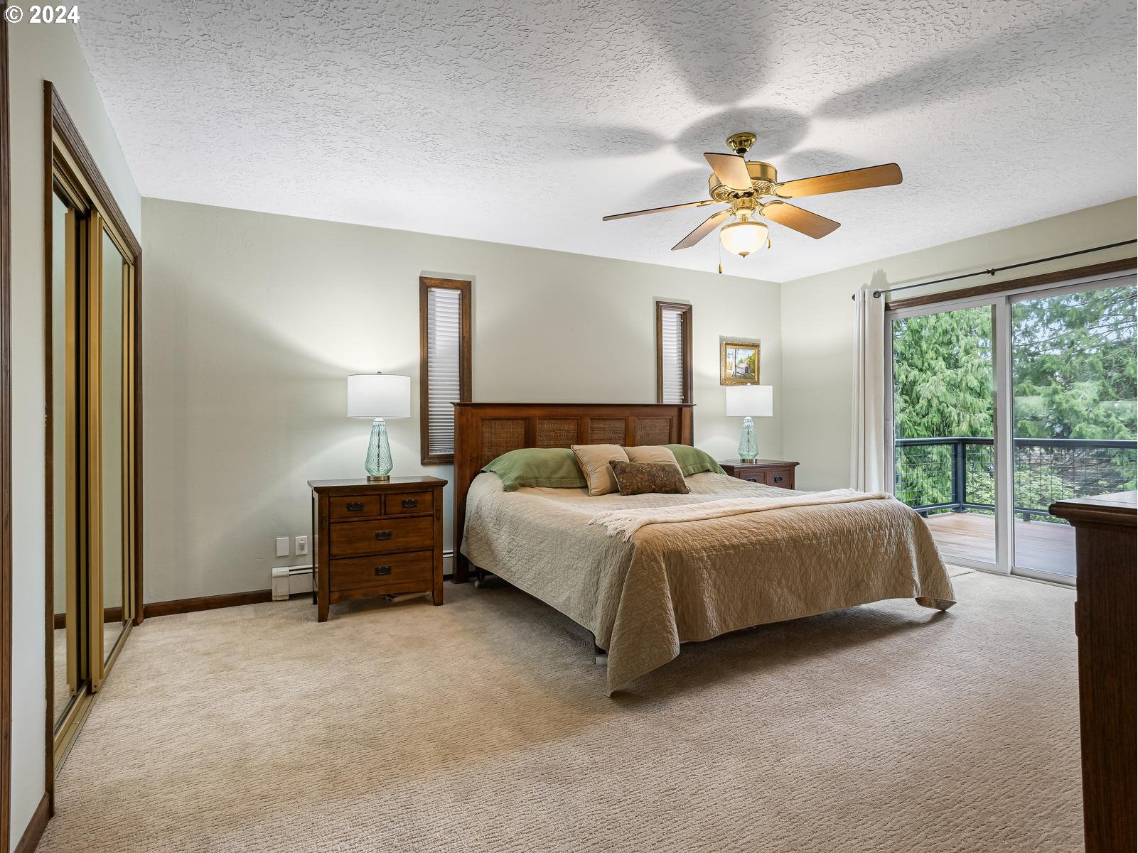 18550 Southeast Jacoby Road Sandy, OR 97055 - Photo 18 of 47 a bedroom with a bed and a chandelier