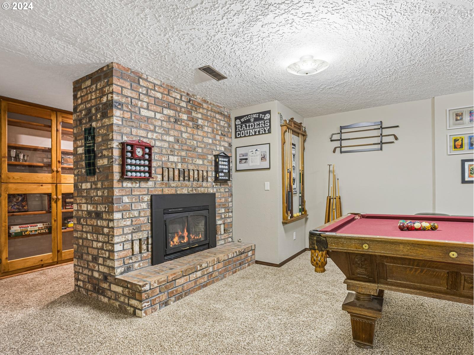 18550 Southeast Jacoby Road Sandy, OR 97055 - Photo 33 of 47 a bedroom with a bed and a fireplace