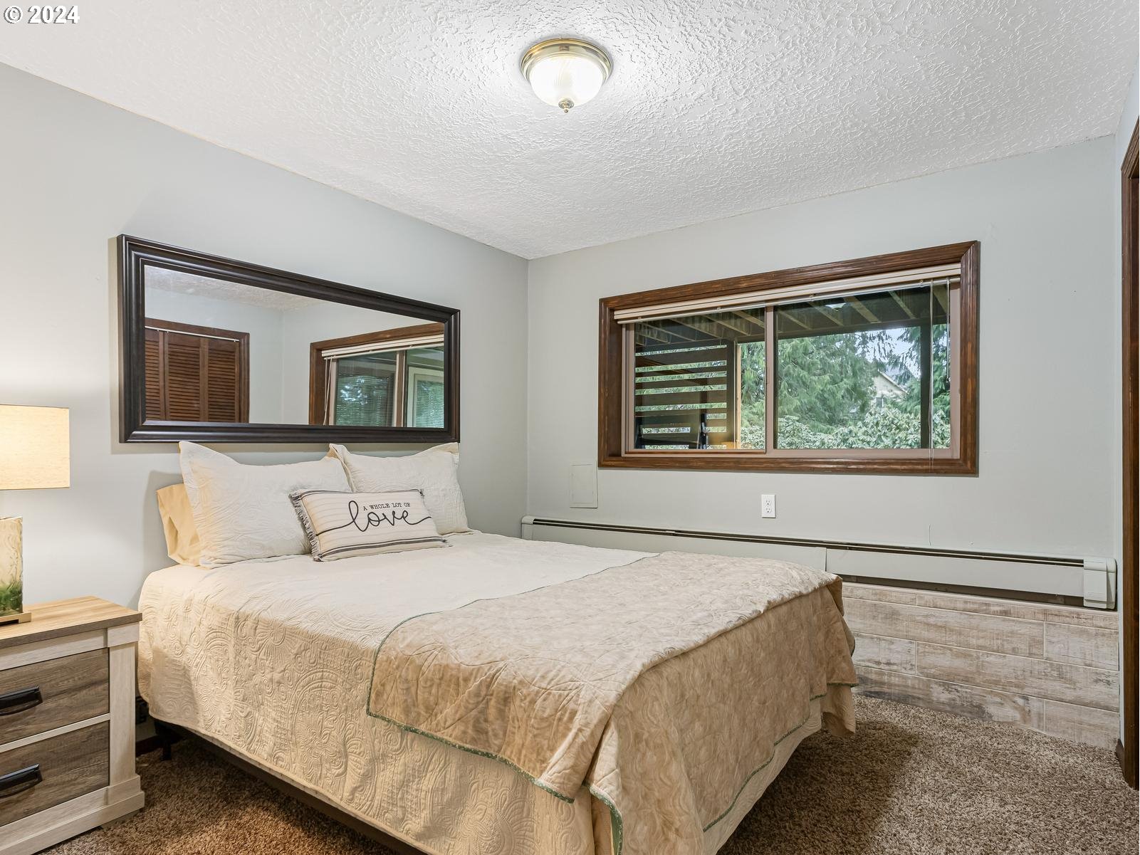 18550 Southeast Jacoby Road Sandy, OR 97055 - Photo 35 of 47 a bedroom with a bed and a painting on the wall