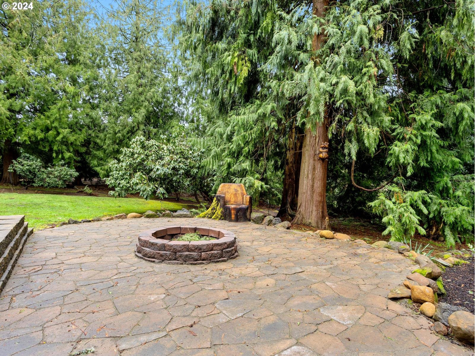 18550 Southeast Jacoby Road Sandy, OR 97055 - Photo 40 of 47 a view of a backyard with table and chairs under an umbrella