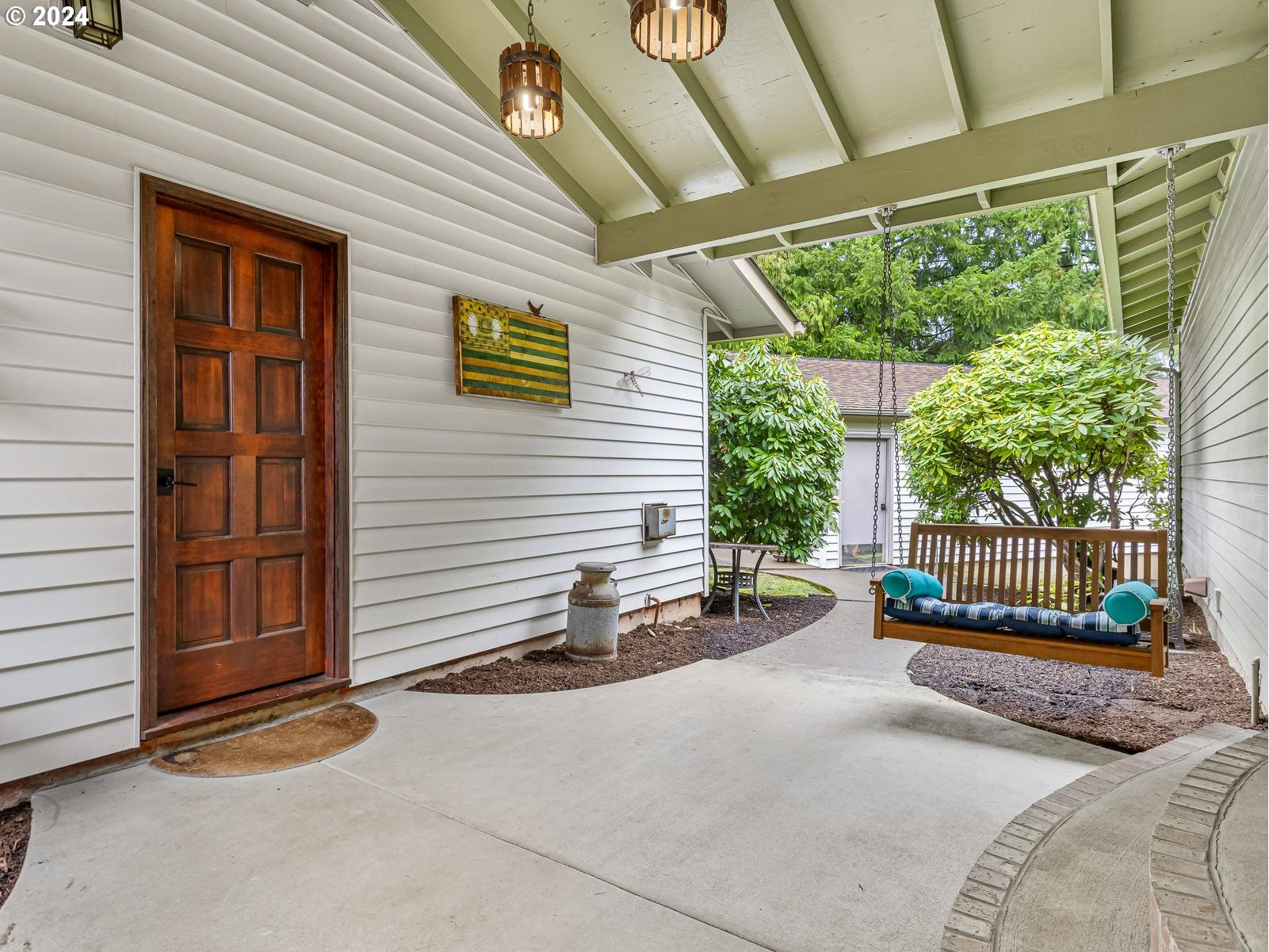 18550 Southeast Jacoby Road Sandy, OR 97055 - Photo 4 of 47 a view of a patio with a table and chairs and potted plants