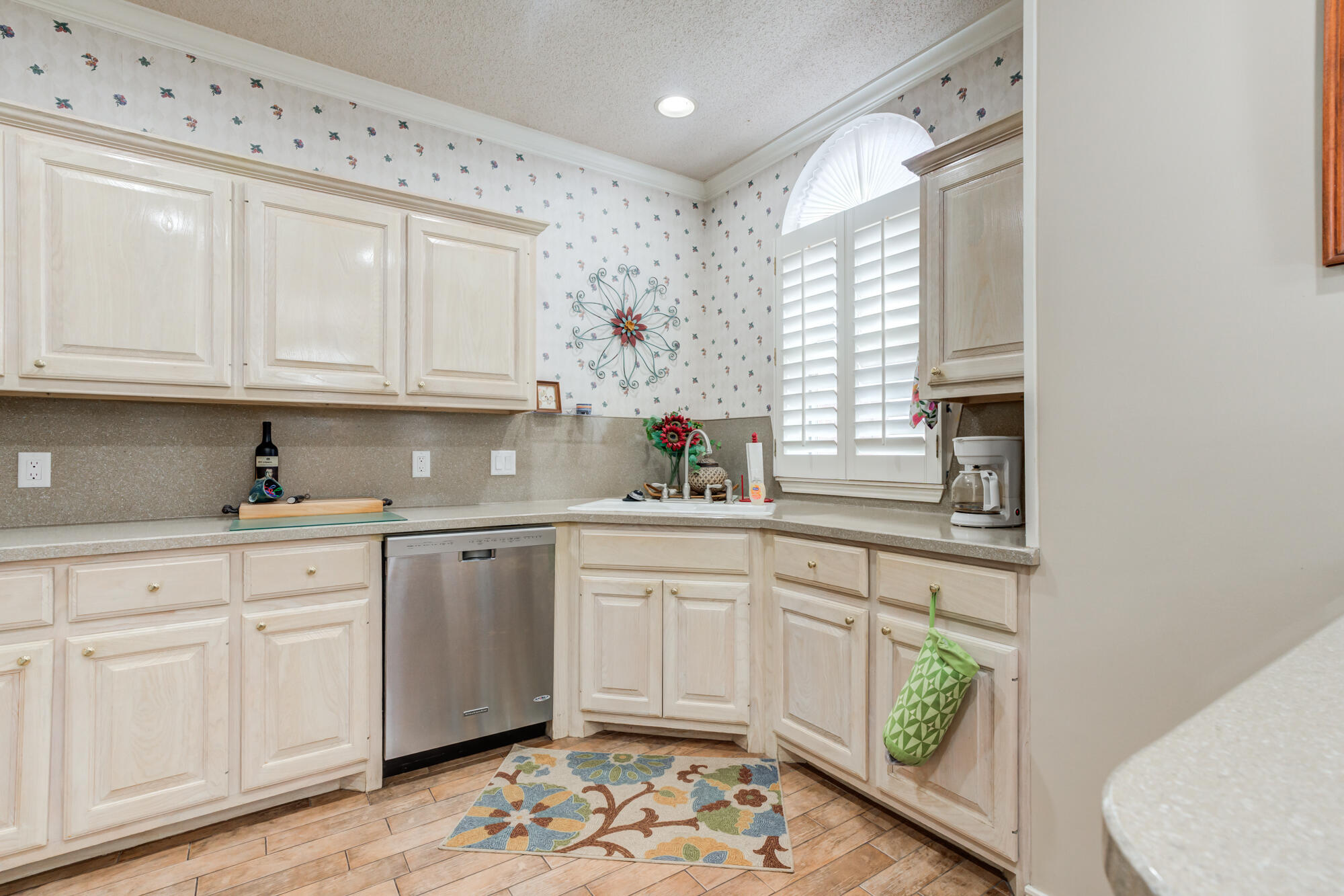 6310 8th Street Lubbock, TX 79416 - Photo 12 of 45 a kitchen with granite countertop white cabinets white appliances and a sink