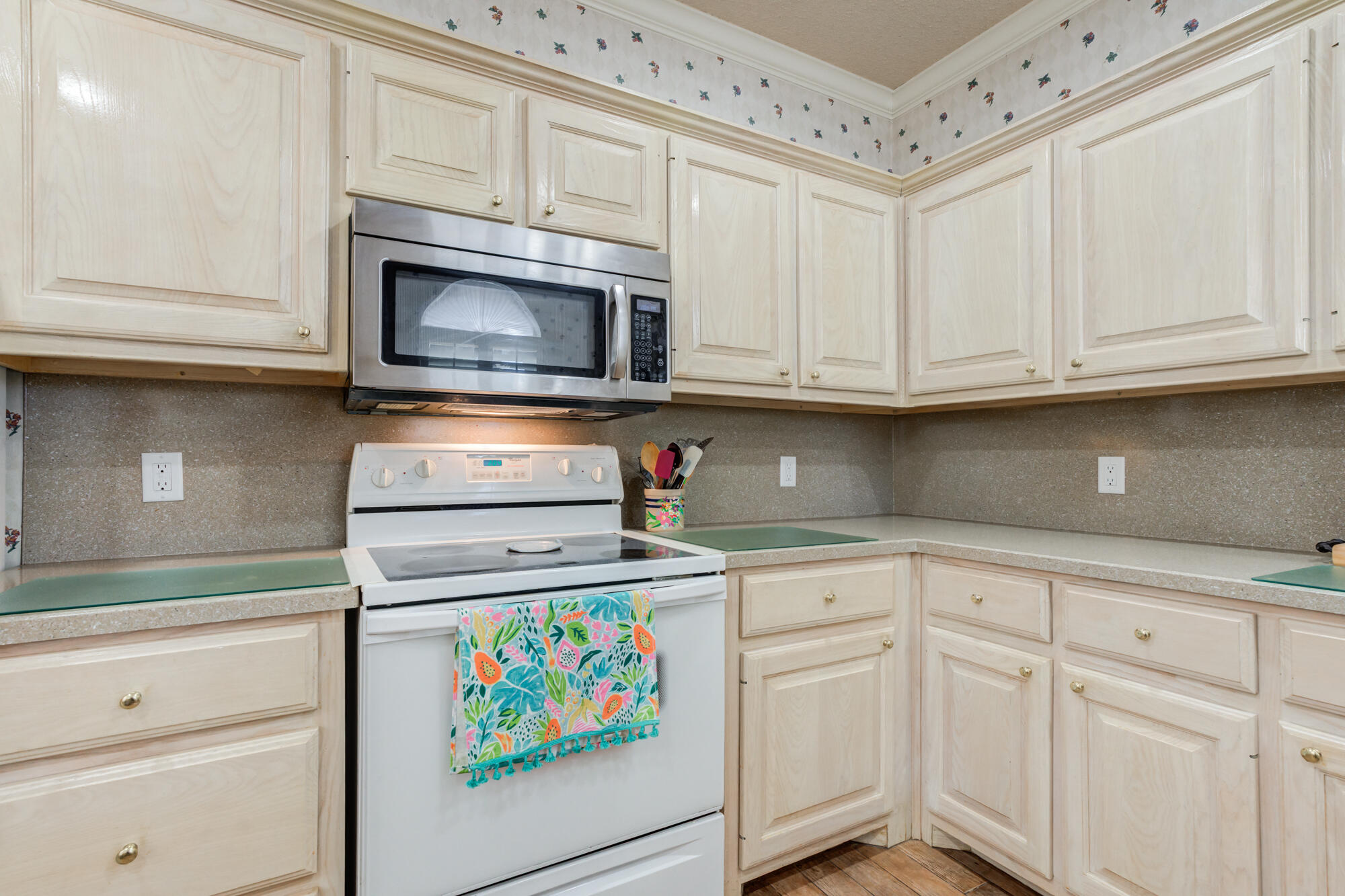 6310 8th Street Lubbock, TX 79416 - Photo 13 of 45 a kitchen with granite countertop white cabinets stainless steel appliances and sink