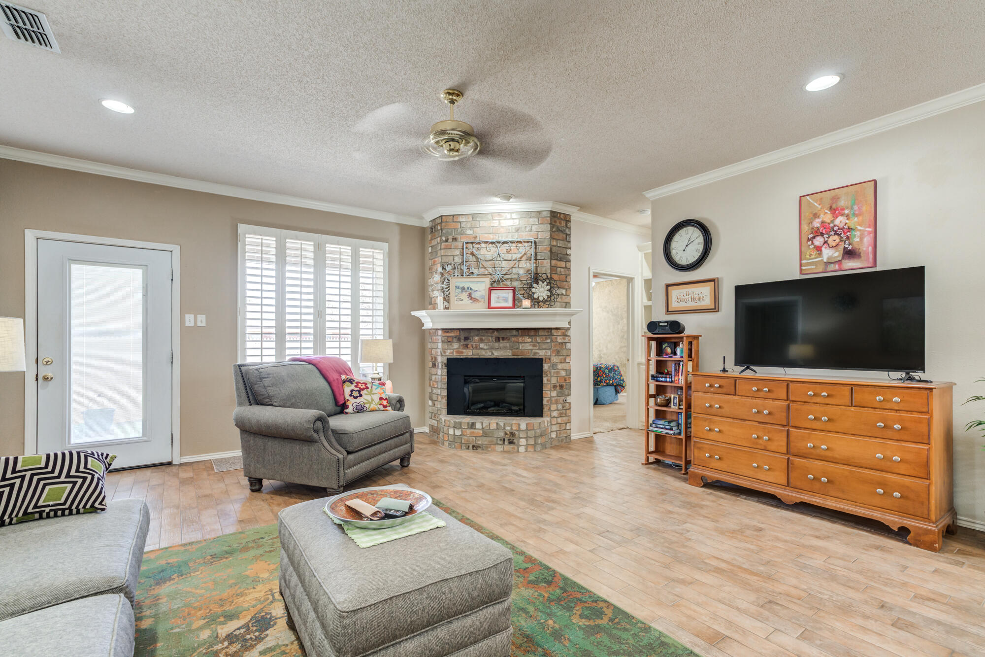 6310 8th Street Lubbock, TX 79416 - Photo 21 of 45 a living room with furniture and a flat screen tv