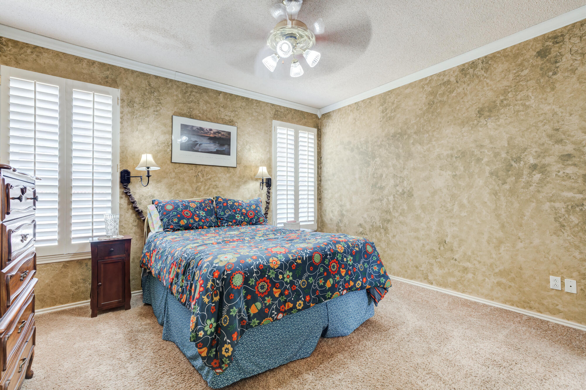 6310 8th Street Lubbock, TX 79416 - Photo 27 of 45 a bedroom with a bed and a chandelier