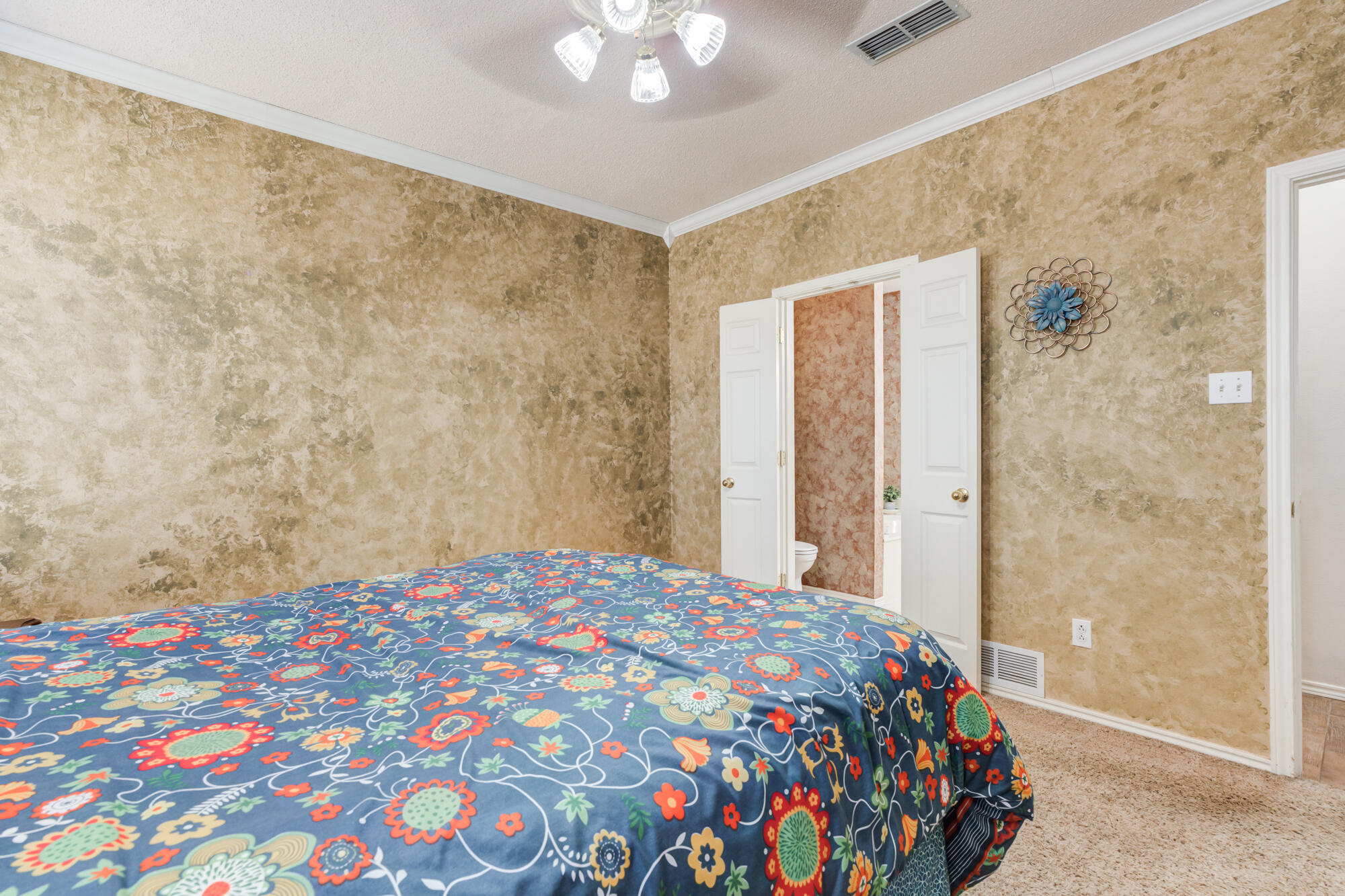 6310 8th Street Lubbock, TX 79416 - Photo 28 of 45 a bedroom with a bed and a lamp on the dresser