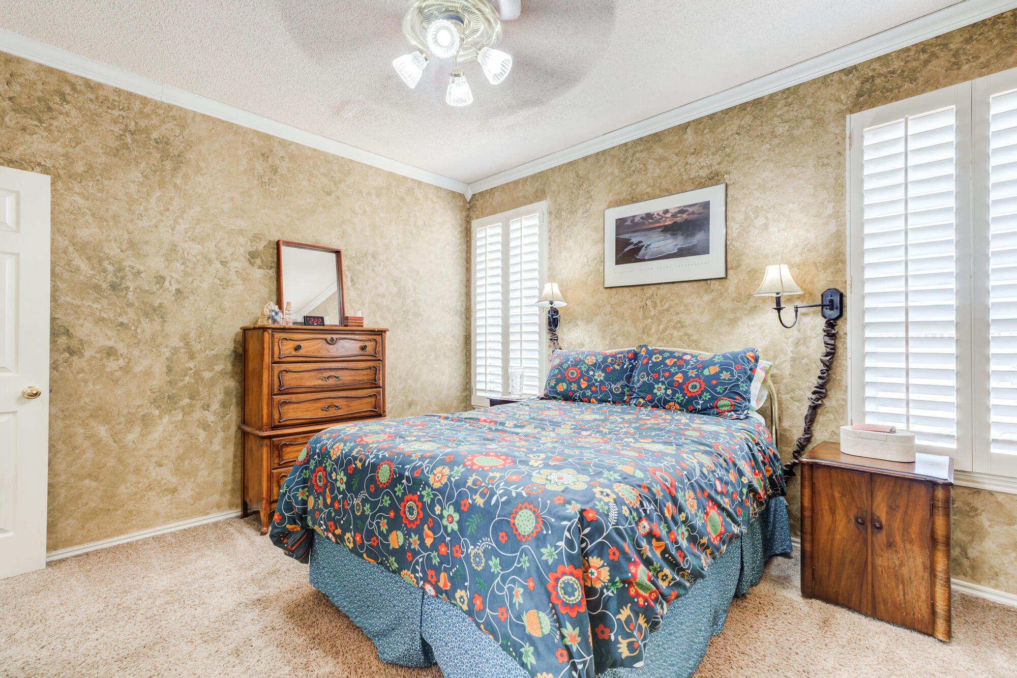 6310 8th Street Lubbock, TX 79416 - Photo 29 of 45 a bedroom with a bed and dresser with mirror