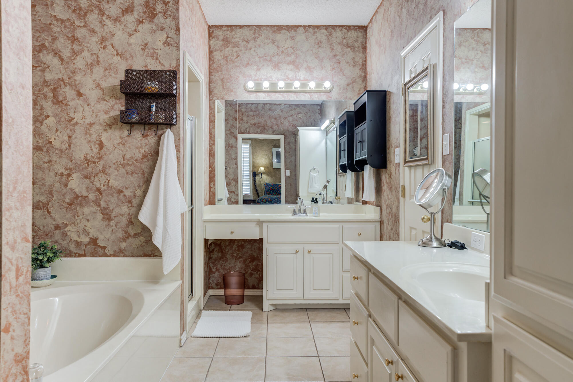 6310 8th Street Lubbock, TX 79416 - Photo 30 of 45 a bathroom with a bathtub sink and mirror