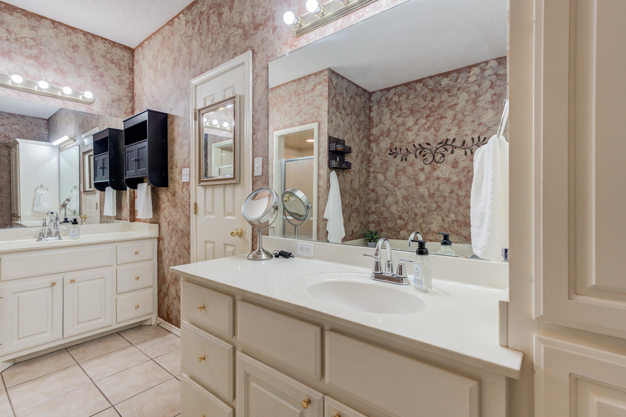 6310 8th Street Lubbock, TX 79416 - Photo 31 of 45 a bathroom with a sink and a mirror