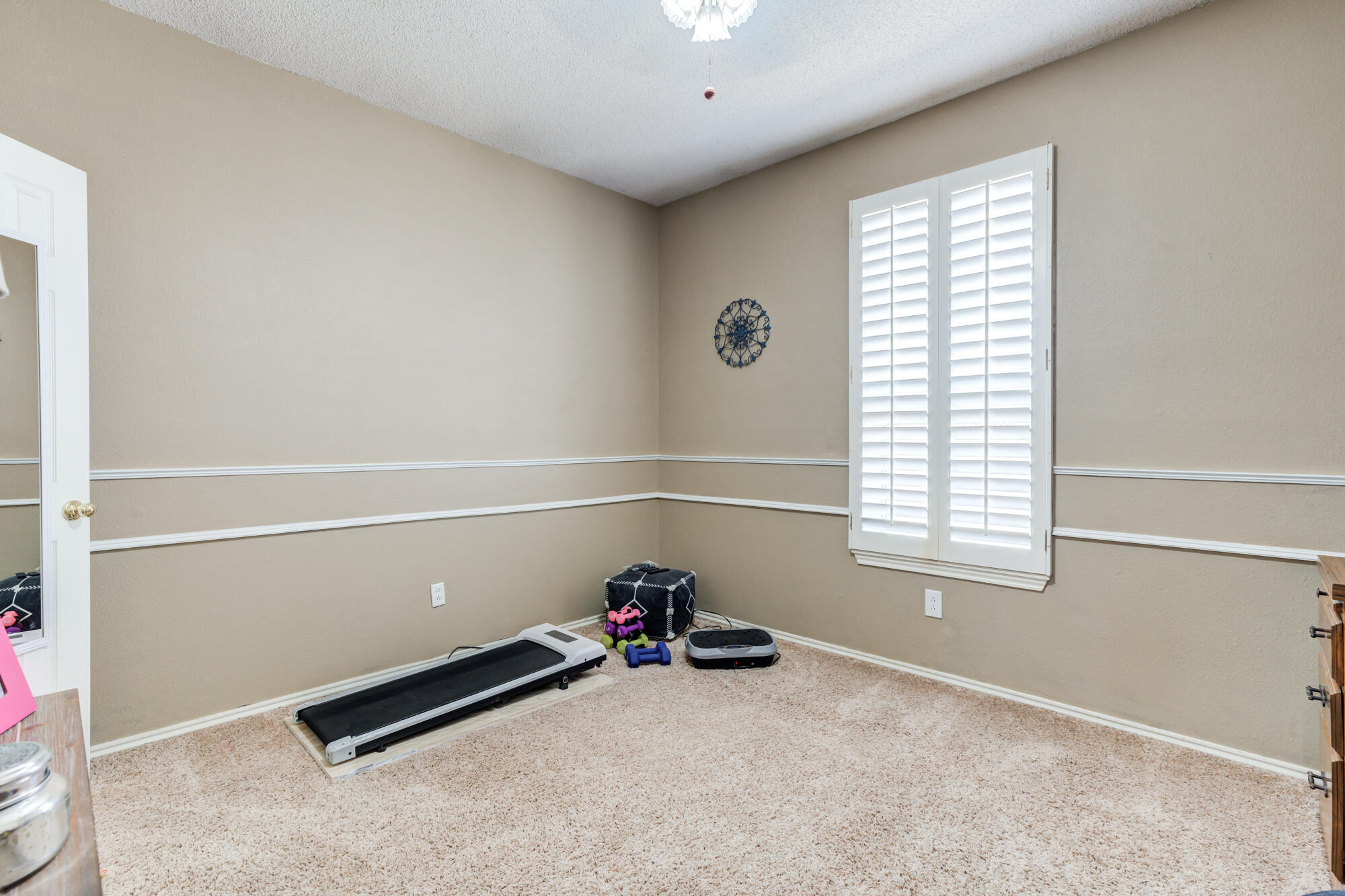 6310 8th Street Lubbock, TX 79416 - Photo 35 of 45 a view of a room with gym equipment and a window