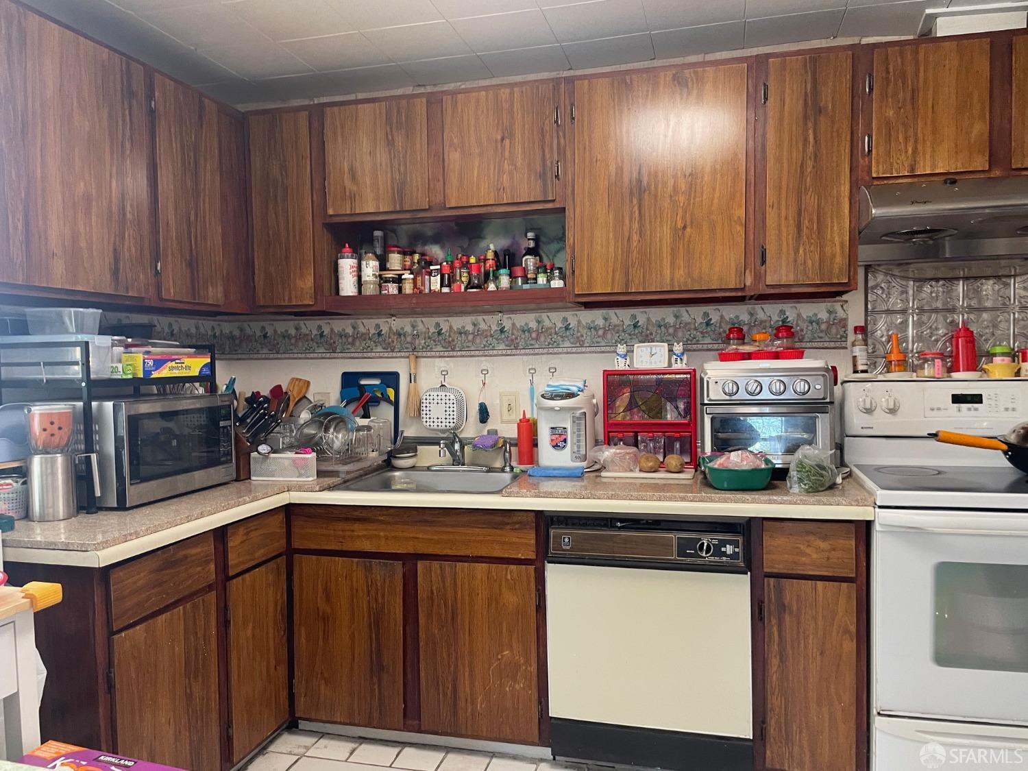168 Park Boulevard Millbrae, CA 94030 - Photo 13 of 19 a kitchen with stainless steel appliances granite countertop a sink and cabinets