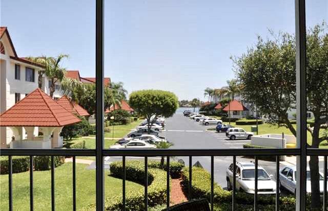 104 Half Moon Circle, Unit B2 Hypoluxo, FL 33462 - Photo 27 of 54 a view of a chairs and table in patio