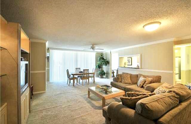 104 Half Moon Circle, Unit B2 Hypoluxo, FL 33462 - Photo 33 of 54 a living room with furniture and a large window