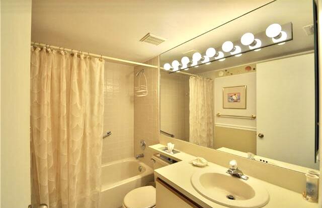 104 Half Moon Circle, Unit B2 Hypoluxo, FL 33462 - Photo 36 of 54 a bathroom with a sink and a mirror