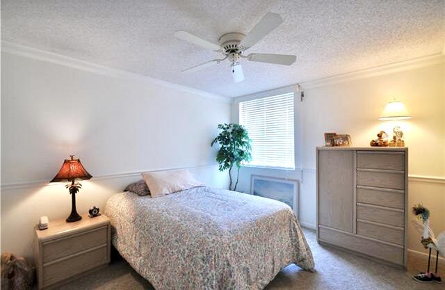 104 Half Moon Circle, Unit B2 Hypoluxo, FL 33462 - Photo 37 of 54 a bedroom with a bed and a dresser