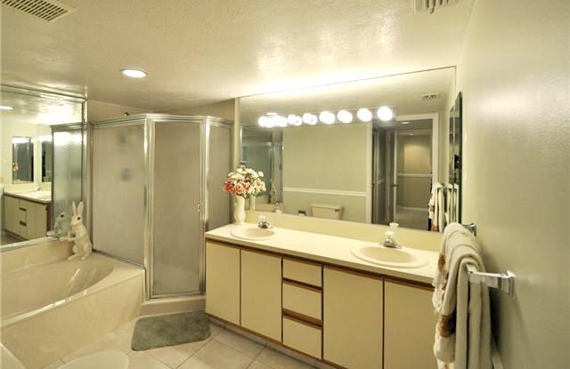 104 Half Moon Circle, Unit B2 Hypoluxo, FL 33462 - Photo 38 of 54 a bathroom with a double vanity sink mirror and shower