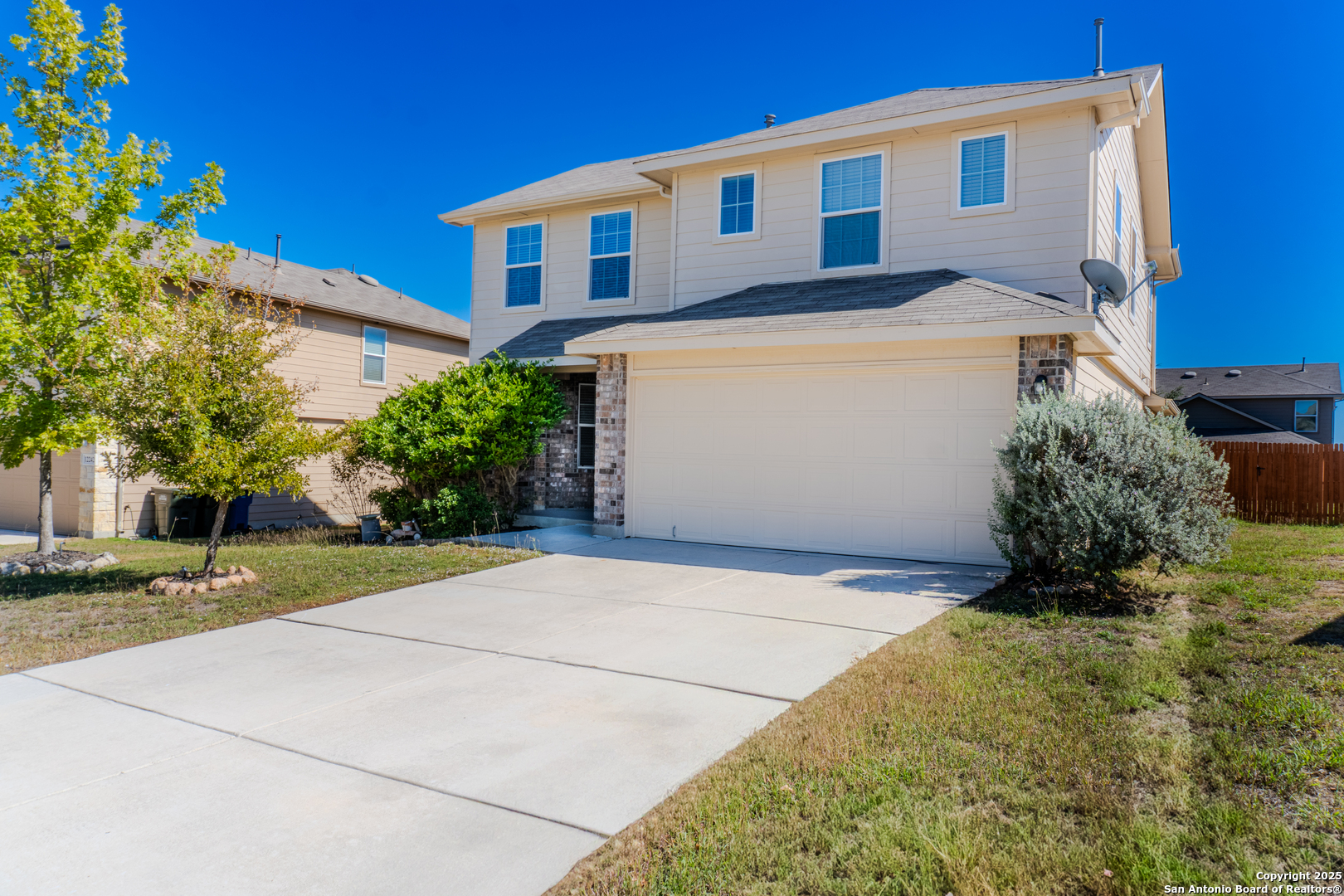 12236 Bening Schertz, TX 78154 - Photo 2 of 16 a front view of a house with a yard and garage