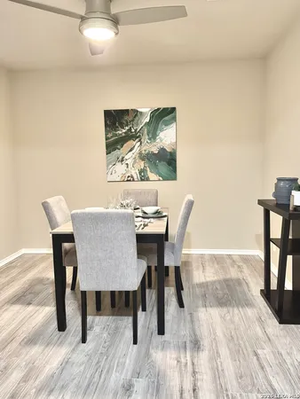 a view of a dining room with furniture and wooden floor