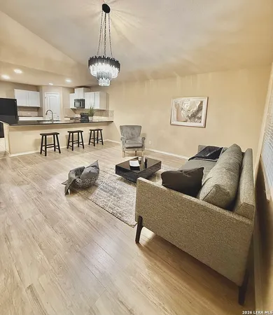 a living room with furniture and kitchen view