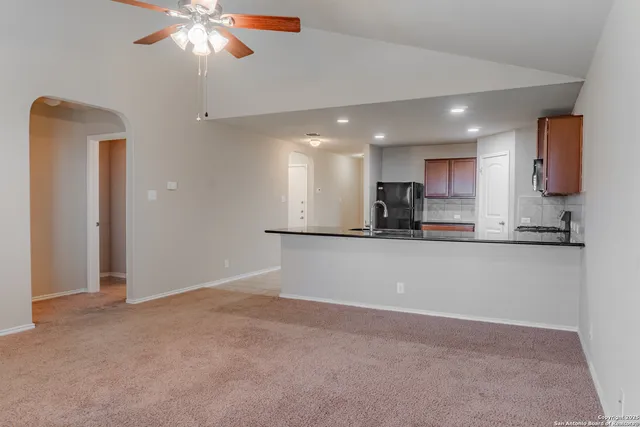 a view of kitchen with refrigerator and microwave