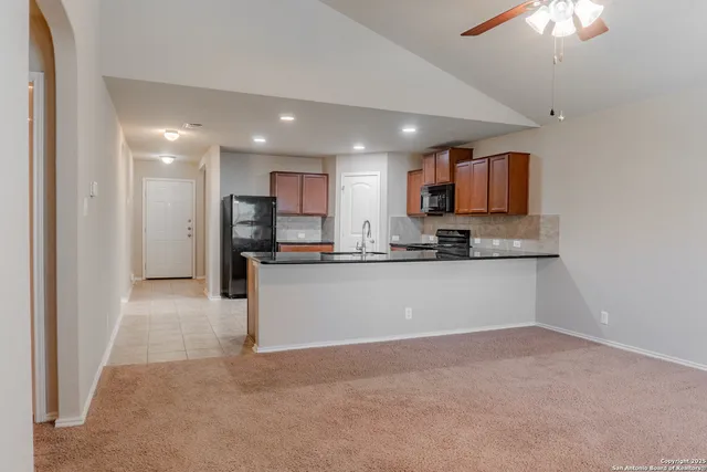a view of kitchen with refrigerator sink and microwave