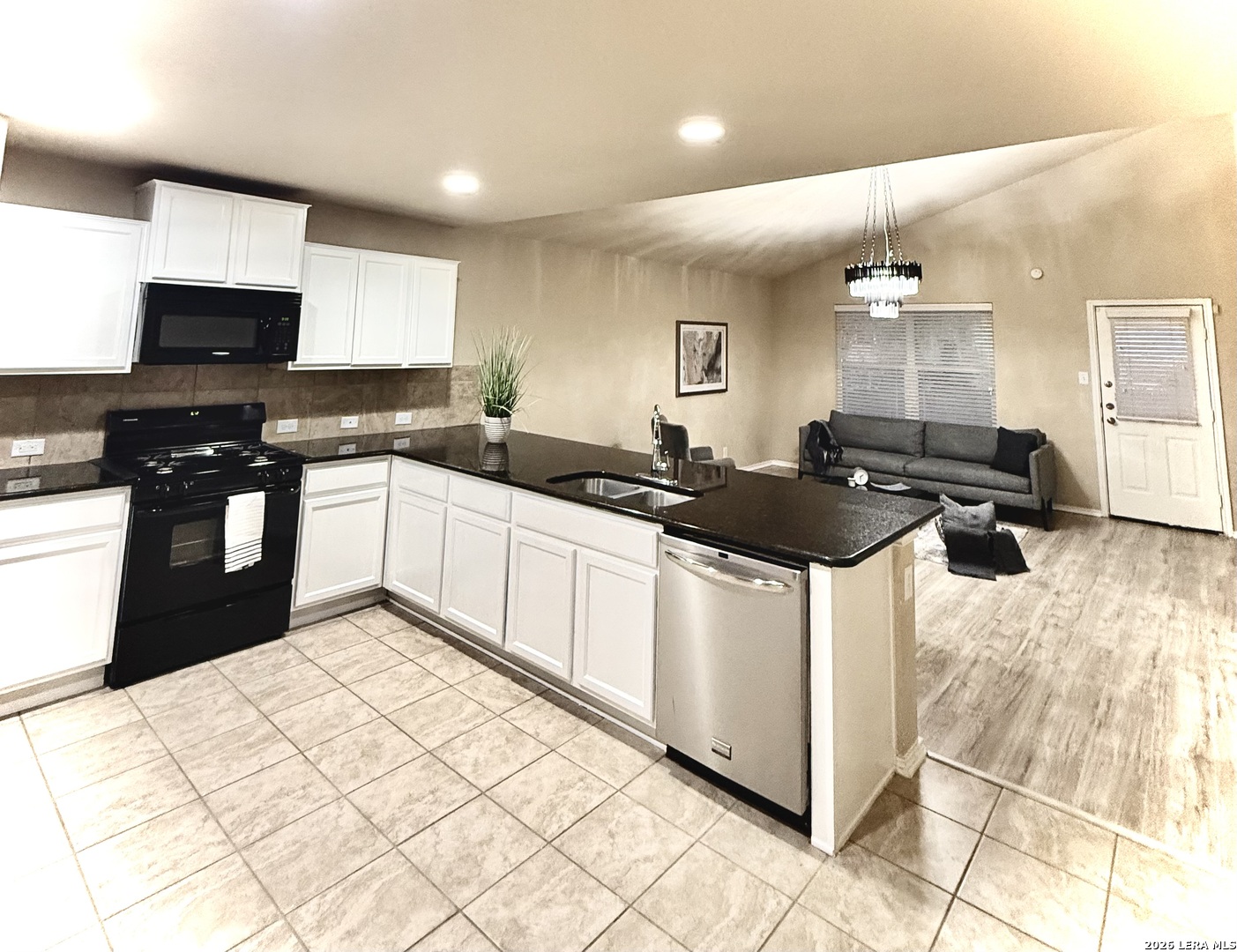 12236 Bening Schertz, TX 78154 - Photo 7 of 16 a kitchen with stainless steel appliances a sink a stove a refrigerator and cabinets