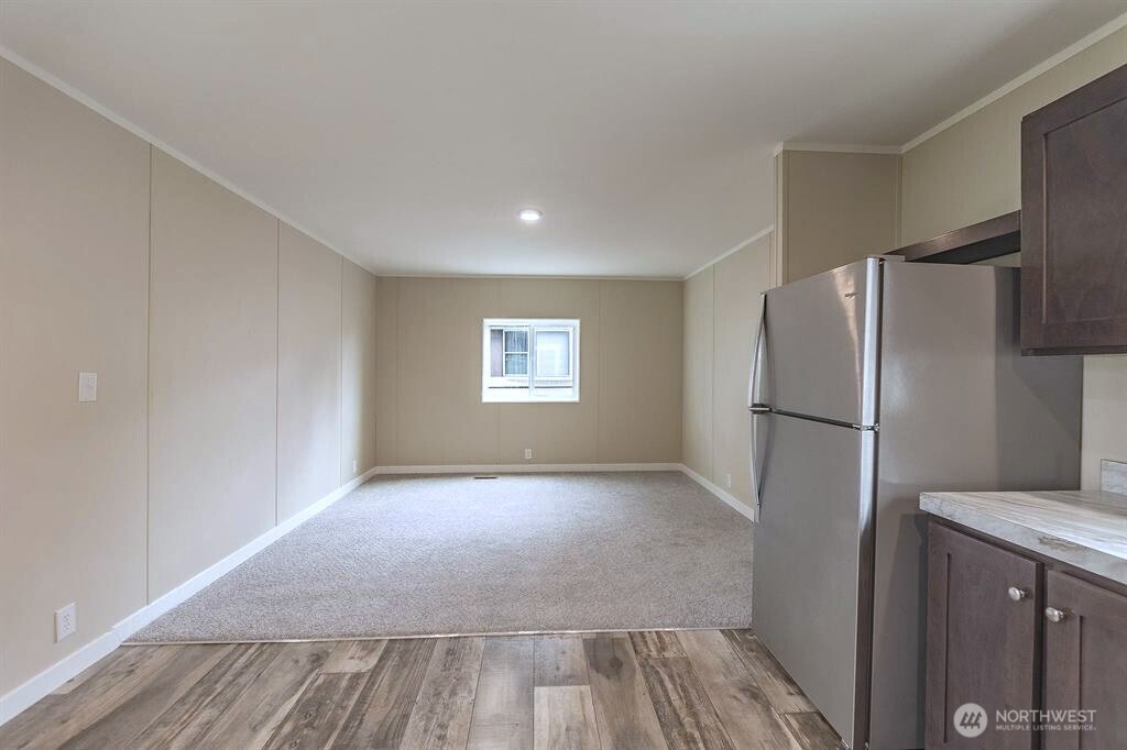 840 West 1st Street, Unit 29 Cheney, WA 99004 - Photo 8 of 20 a view of a kitchen with a refrigerator cabinets and wooden floor