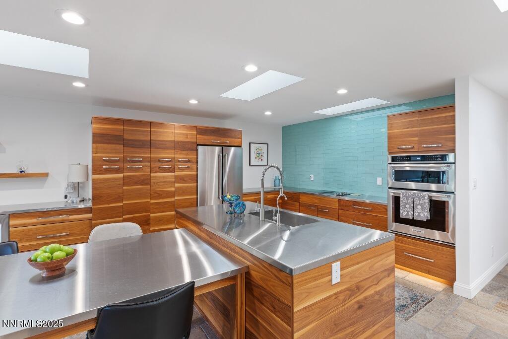 4811 Lakeridge Terrace West Reno, NV 89509 - Photo 18 of 43 a kitchen with stainless steel appliances granite countertop a sink and a stove