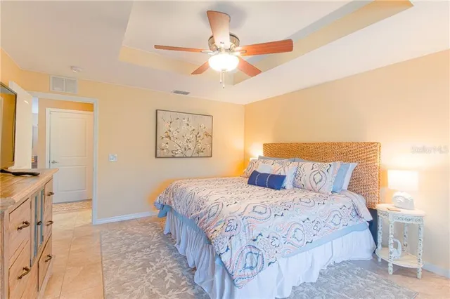 a bedroom with a large bed and a chandelier