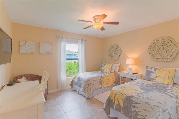 a bedroom with two beds and a chandelier