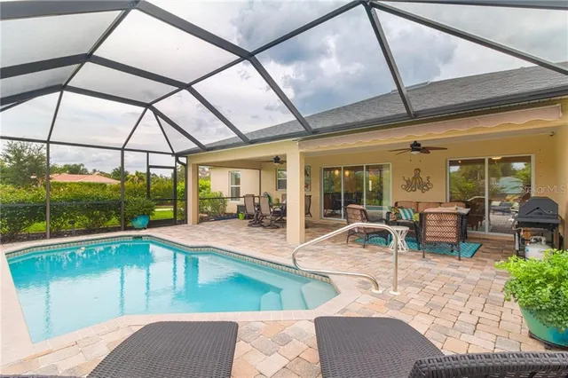 a view of a patio with swimming pool table and chairs