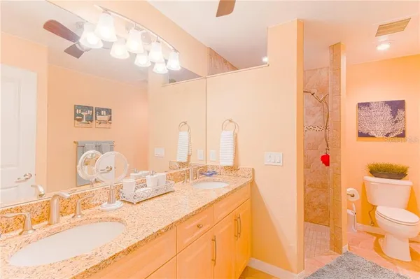 a bathroom with a sink vanity mirror and toilet