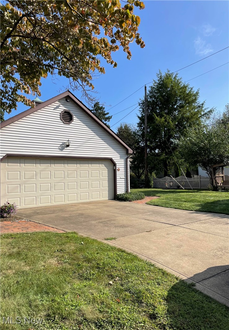 730 Phillips Road Northeast Massillon, OH 44646 - Photo 26 of 27 2 car garage featuring a lawn and concrete driveway