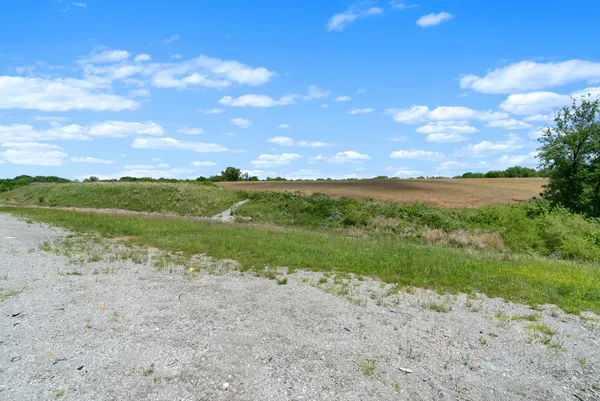 a view of a field with an ocean